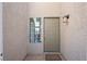 Inviting front entrance with a neutral-colored door and textured exterior at 5458 Walton Heath Ave, Las Vegas, NV 89142