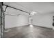 Two-car garage with concrete floors and a rear entrance into the house at 5458 Walton Heath Ave, Las Vegas, NV 89142