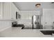 Modern kitchen with stainless steel refrigerator, white cabinets, and sleek countertops at 5458 Walton Heath Ave, Las Vegas, NV 89142