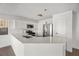 Open kitchen with sleek countertops, stainless steel appliances, and bright white cabinetry at 5458 Walton Heath Ave, Las Vegas, NV 89142