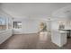 Spacious living room offers plank floors, abundant light, and a view to the backyard through sliding glass doors at 5458 Walton Heath Ave, Las Vegas, NV 89142