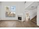 Bright living room features high ceilings, a fireplace, large windows, and access to a staircase at 5458 Walton Heath Ave, Las Vegas, NV 89142