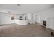 Open concept living space with modern tile flooring, white walls, and a view of the kitchen at 5458 Walton Heath Ave, Las Vegas, NV 89142