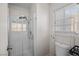 Shower featuring glass door with tiled walls, a shower head and temperature handles at 5458 Walton Heath Ave, Las Vegas, NV 89142