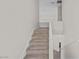 Carpeted staircase leading to the upper level with white railing at 5458 Walton Heath Ave, Las Vegas, NV 89142
