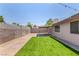 Spacious backyard features a patio, artificial grass, and privacy wall at 5734 Duval Dr, Las Vegas, NV 89156