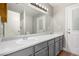 Bright bathroom with double sinks, ample counter space, and a large vanity mirror at 5734 Duval Dr, Las Vegas, NV 89156