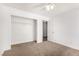 This cozy bedroom features neutral carpet, a ceiling fan, and a large closet at 5734 Duval Dr, Las Vegas, NV 89156