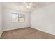 Light-filled bedroom with neutral carpet, a ceiling fan, and a bright window at 5734 Duval Dr, Las Vegas, NV 89156