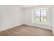 Bedroom featuring neutral carpet and a large window with a neighborhood view at 5734 Duval Dr, Las Vegas, NV 89156