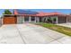 Charming single-story home featuring a red tile roof, solar panels, and a large driveway at 5734 Duval Dr, Las Vegas, NV 89156