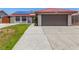 Charming single-story home featuring a red tile roof, solar panels, and a two-car garage at 5734 Duval Dr, Las Vegas, NV 89156