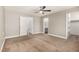 Spacious main bedroom with neutral carpet, a ceiling fan, and adjoining bathroom and closet at 5734 Duval Dr, Las Vegas, NV 89156