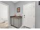A bar area with granite countertop, cabinet storage, and a door leading to a powder room at 6106 Castle Gardens Ave, Las Vegas, NV 89130