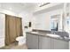 Bathroom featuring double sinks, granite counters, and a shower-tub combo at 6106 Castle Gardens Ave, Las Vegas, NV 89130