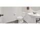 A white bathroom featuring a pedestal sink, toilet, and tile flooring at 6106 Castle Gardens Ave, Las Vegas, NV 89130