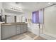 Well-lit bathroom featuring double vanity, soaking tub and glass-enclosed shower at 6106 Castle Gardens Ave, Las Vegas, NV 89130