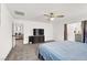 Carpeted bedroom with ceiling fan, large TV, dresser, and ensuite at 6106 Castle Gardens Ave, Las Vegas, NV 89130