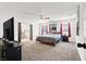 Spacious bedroom with neutral carpet, ceiling fan, and en-suite bathroom access at 6106 Castle Gardens Ave, Las Vegas, NV 89130