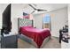 This bedroom boasts a plush upholstered headboard and large window at 6106 Castle Gardens Ave, Las Vegas, NV 89130