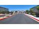 Gated community entrance with brick pillars and landscaped surroundings for added security and aesthetic appeal at 6106 Castle Gardens Ave, Las Vegas, NV 89130
