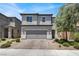 Charming two-story home with a well-maintained front yard and a two-car garage at 6106 Castle Gardens Ave, Las Vegas, NV 89130