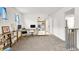 Bright landing area featuring carpet flooring, natural light, and adjacent workspace at 6106 Castle Gardens Ave, Las Vegas, NV 89130