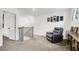 Upstairs landing area includes neutral carpet, modern artwork, and a comfortable reading chair at 6106 Castle Gardens Ave, Las Vegas, NV 89130