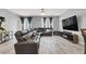 Spacious living room with modern decor, large windows, and a comfortable sectional sofa at 6106 Castle Gardens Ave, Las Vegas, NV 89130