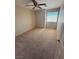 A cozy bedroom with neutral walls, carpeted floors, and a large window at 6425 Sierra Sands St, North Las Vegas, NV 89086