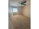 A cozy bedroom with neutral walls, carpeted floors, and a large window at 6425 Sierra Sands St, North Las Vegas, NV 89086