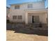 Two-story home exterior with a covered patio, sliding glass doors, and minimal landscaping at 6425 Sierra Sands St, North Las Vegas, NV 89086
