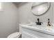 Modern half bathroom featuring a white vanity with marble countertop and a black faucet at 7135 Polaris Ave, Las Vegas, NV 89118