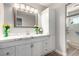 Bathroom featuring a white vanity with white marble countertop and glass shower at 7135 Polaris Ave, Las Vegas, NV 89118