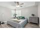 Cozy bedroom with wood-look tile flooring, a ceiling fan, and a gray dresser at 7135 Polaris Ave, Las Vegas, NV 89118