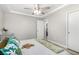 Bright bedroom with a ceiling fan, door to hall, closet and tray ceiling at 7135 Polaris Ave, Las Vegas, NV 89118