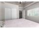 Neutral bedroom featuring a large window and closet with sliding doors at 7135 Polaris Ave, Las Vegas, NV 89118