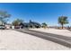Spacious property with a long driveway leading to a gray home with solar panels at 7135 Polaris Ave, Las Vegas, NV 89118