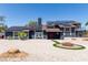Beautiful two-story home featuring solar panels, double doors, and a charming fire pit area at 7135 Polaris Ave, Las Vegas, NV 89118