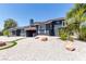 Inviting two-story home with solar panels, a balcony, and a gravel yard at 7135 Polaris Ave, Las Vegas, NV 89118