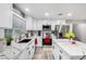 Stylish kitchen with white cabinets, marble countertops, stainless steel appliances, and wood-look tile flooring at 7135 Polaris Ave, Las Vegas, NV 89118