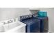Well-equipped laundry room with a washing machine, dryer and a sink at 7135 Polaris Ave, Las Vegas, NV 89118