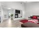 Cozy living room with a fireplace, high ceilings, and wood-look tile flooring at 7135 Polaris Ave, Las Vegas, NV 89118
