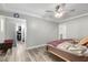 Bright main bedroom with wood-look tile flooring and access to a walk-in closet at 7135 Polaris Ave, Las Vegas, NV 89118