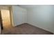 Bedroom with a closet, neutral carpet, and a door leading to the hallway at 7375 Davenbury St, Las Vegas, NV 89113