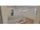 Bright hallway with a white railing, neutral carpet, and natural light from three windows at 7375 Davenbury St, Las Vegas, NV 89113