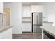 Stainless steel refrigerator stands out in this minimalist kitchen at 7777 Vino Vranec Ct, Las Vegas, NV 89113