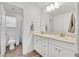 Bright bathroom featuring a double sink vanity and a door leading to the toilet and shower at 8011 Cavazzo Ave, Las Vegas, NV 89178