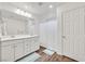 Bathroom with double sink vanity, wood-look flooring, and a shower with a curtain at 8011 Cavazzo Ave, Las Vegas, NV 89178