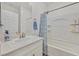 Bright bathroom with a shower-tub combo featuring a patterned shower curtain and a single-sink vanity at 8011 Cavazzo Ave, Las Vegas, NV 89178